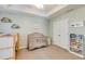 Cozy bedroom with ceiling fan, a crib, and natural light, perfect for a relaxing space at 820 Ash St, Canton, GA 30114