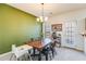 Bright dining room features a modern chandelier, rustic wood table, and views to the backyard at 820 Ash St, Canton, GA 30114