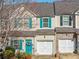 Inviting townhome featuring a blue front door and attached one-car garage at 820 Ash St, Canton, GA 30114