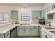 Well-lit kitchen with ample counter space, and neutral colored cabinetry at 820 Ash St, Canton, GA 30114