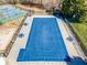 Aerial view of a community pool covered for the off-season, surrounded by lounge chairs at 820 Ash St, Canton, GA 30114