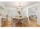 Charming dining room featuring a round table, wicker chairs, and a modern light fixture at 850 Moores Mill Nw Rd, Atlanta, GA 30327