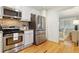 Modern kitchen with stainless steel appliances, granite countertops, and a view into the dining area at 850 Moores Mill Nw Rd, Atlanta, GA 30327