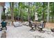 Outdoor patio with dining table, chairs, and a fire pit in a serene backyard setting at 850 Moores Mill Nw Rd, Atlanta, GA 30327