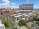 An elevated view of a residential neighborhood with lush greenery, a commercial district and well-maintained brick apartment buildings at 1903 Anjaco Nw Rd # 3, Atlanta, GA 30309