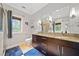 Elegant bathroom featuring double sinks, granite countertops, dark wood cabinets, and a tiled shower at 1903 Anjaco Nw Rd # 3, Atlanta, GA 30309