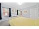 Bedroom featuring a white bed, a desk, and two windows with dark curtains at 1903 Anjaco Nw Rd # 3, Atlanta, GA 30309