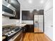 View of kitchen with stainless steel appliances, dark wood cabinets, and granite countertops at 1903 Anjaco Nw Rd # 3, Atlanta, GA 30309