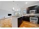 Modern kitchen with island, stainless steel appliances, and hardwood floors at 1903 Anjaco Nw Rd # 3, Atlanta, GA 30309