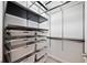 Well-designed walk-in closet with multiple shelves, drawers, and hanging rods for optimized storage solutions at 1903 Anjaco Nw Rd # 3, Atlanta, GA 30309