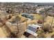 Aerial view of a home with a long front porch, detached garage, and large outbuilding at 3200 Fence Rd, Dacula, GA 30019