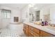 Bright bathroom with a soaking tub, dual sinks, and a decorative vanity at 3200 Fence Rd, Dacula, GA 30019