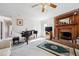 Cozy living room featuring a brick fireplace, piano, plush carpet, and ample natural light at 3200 Fence Rd, Dacula, GA 30019