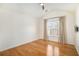 Bright bedroom featuring beautiful hardwood floors, a ceiling fan and window with light-filtering curtains at 3215 Belford Dr, Marietta, GA 30066