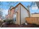 Angled view of the home's side exterior with brick, siding, fenced yard and mature trees at 3215 Belford Drive, Marietta, GA 30066