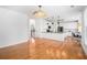 Open-concept living room with hardwood floors, modern light fixtures, and a nearby kitchen at 3215 Belford Drive, Marietta, GA 30066