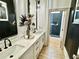 Stylish bathroom with marble countertops, dual sinks, and a walk-in shower with black accents at 590 Hood Ave, Fayetteville, GA 30214