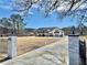 Long driveway leading to a modern farmhouse-style home surrounded by a spacious front yard at 590 Hood Ave, Fayetteville, GA 30214