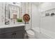 Stylish bathroom with a tub/shower combo, grey vanity, and modern wallpaper design at 886 Cedar Creek Se Ct, Marietta, GA 30067