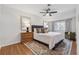 Comfortable bedroom featuring hardwood floors, ceiling fan, and a large window for ample natural light at 886 Cedar Creek Se Ct, Marietta, GA 30067