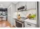 Bright kitchen with stainless appliances, white countertops, and a connecting dining area at 886 Cedar Creek Se Ct, Marietta, GA 30067