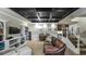 Finished basement area with coffered ceiling, kitchenette, and comfortable seating at 9937 Between The Grns, Villa Rica, GA 30180