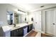 Bathroom vanity featuring double sinks, dark wood cabinets, and a large framed mirror at 9937 Between The Grns, Villa Rica, GA 30180