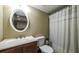 Cozy bathroom features a vanity, toilet, and shower with curtain at 9937 Between The Grns, Villa Rica, GA 30180