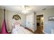 Charming bedroom with a unicorn bed frame, stylish fan, and a doorway leading to a bathroom at 9937 Between The Grns, Villa Rica, GA 30180