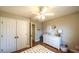 Cozy bedroom featuring hardwood floors, neutral walls, a double door closet, and a dresser at 9937 Between The Grns, Villa Rica, GA 30180