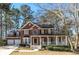 Charming two-story brick home with a welcoming front porch and well-maintained landscaping at 9937 Between The Grns, Villa Rica, GA 30180