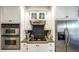 Close-up of kitchen appliances, including double ovens, stovetop and stainless steel refrigerator at 9937 Between The Grns, Villa Rica, GA 30180