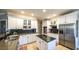 Kitchen with white cabinets, black countertops, stainless appliances and an island at 9937 Between The Grns, Villa Rica, GA 30180