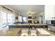 Open-concept kitchen view featuring the sink, and sightlines into the living room with fireplace at 9937 Between The Grns, Villa Rica, GA 30180