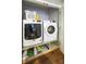 Laundry room with a front load washer and dryer, plus built in storage at 9937 Between The Grns, Villa Rica, GA 30180