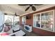 Covered porch featuring ceiling fan, outdoor seating, brick walls, and natural light at 9937 Between The Grns, Villa Rica, GA 30180