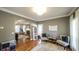 Inviting sitting room with hardwood floors and natural light connects to the living area through an archway at 9937 Between The Grns, Villa Rica, GA 30180