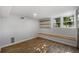 Finished basement showcasing wood flooring, built-in wood bench, and ample natural light, providing a cozy and versatile area at 10 Claire Se Dr, Atlanta, GA 30315