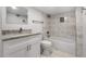 Elegant bathroom featuring a modern vanity, granite countertops, and a tiled shower-tub combination with sleek fixtures at 10 Claire Se Dr, Atlanta, GA 30315
