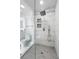 Bathroom featuring frameless glass shower with bench, gray tiled floor, and modern fixtures at 10 Claire Se Dr, Atlanta, GA 30315