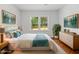 Bright bedroom featuring a plush bed, light hardwood floors, and vibrant decor, creating a serene and inviting space at 10 Claire Se Dr, Atlanta, GA 30315