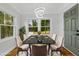 Dining room with modern light fixture, large windows, dining table with seating, and hardwood floors at 10 Claire Se Dr, Atlanta, GA 30315