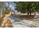 Well-manicured lawn and long driveway leading to a cozy home, surrounded by mature trees, offering a serene setting at 10 Claire Se Dr, Atlanta, GA 30315