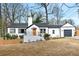 Charming white home with a dark roof, an orange front door, and well-maintained landscaping for great curb appeal at 10 Claire Se Dr, Atlanta, GA 30315