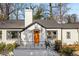 Charming single-Gathering home with a brick exterior, a well-manicured lawn, and a bright orange front door at 10 Claire Se Dr, Atlanta, GA 30315