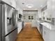 Modern kitchen featuring stainless steel appliances, white cabinets, and hardwood floors at 10 Claire Se Dr, Atlanta, GA 30315