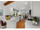 Bright kitchen featuring white cabinetry, stainless steel appliances, breakfast bar, and hardwood floors at 10 Claire Se Dr, Atlanta, GA 30315