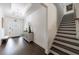 Elegant foyer featuring dark wood floors, a stylish console table, and an open staircase, creating a grand entrance at 1353 Dogleg Road, Marietta, GA 30066