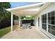 Backyard featuring a covered patio with a hot tub, perfect for relaxation and entertaining at 3047 Standing Rock Ct, Lithia Springs, GA 30122