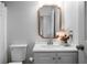 Bathroom featuring modern mirror, toilet and vanity with sink at 3047 Standing Rock Ct, Lithia Springs, GA 30122